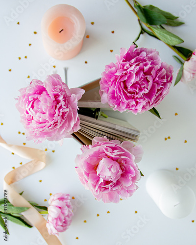 bouquet of pink peonies with a book