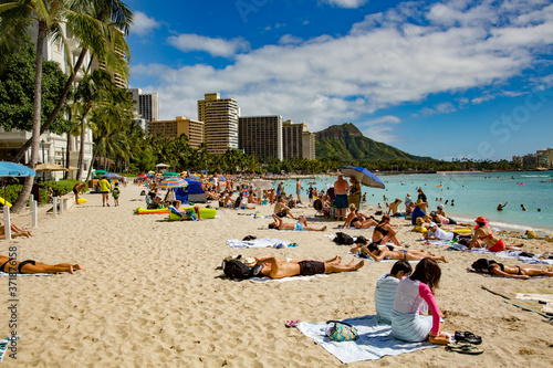 Waikiki, Hawaii;  Waikiki, Hawaii;  Sun bathers and swimmers on the beach in front of major hotels at Waikiki, Hawaii.
