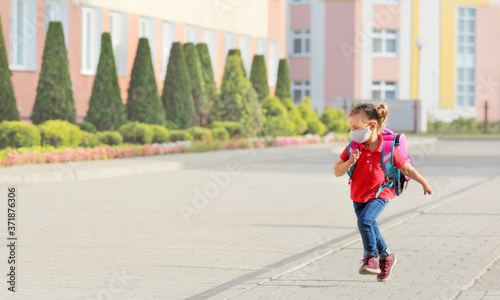 a child in a red t shirt and blue jeans skips to school © ShunTerra