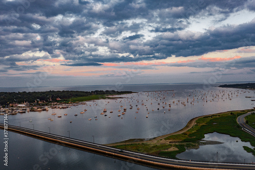 sunset over harbor sailboats