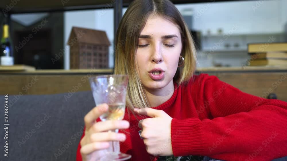 Lady holding glass of champagne while looking at camera.