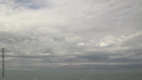 Grey sky low clouds cumulous stratus over green blue aqua calm lake storm Lake Huron Ontario Chantry static photo