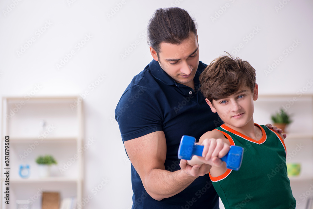 Father and son doing sport exercises indoors Father and son doing sport exercises indoors