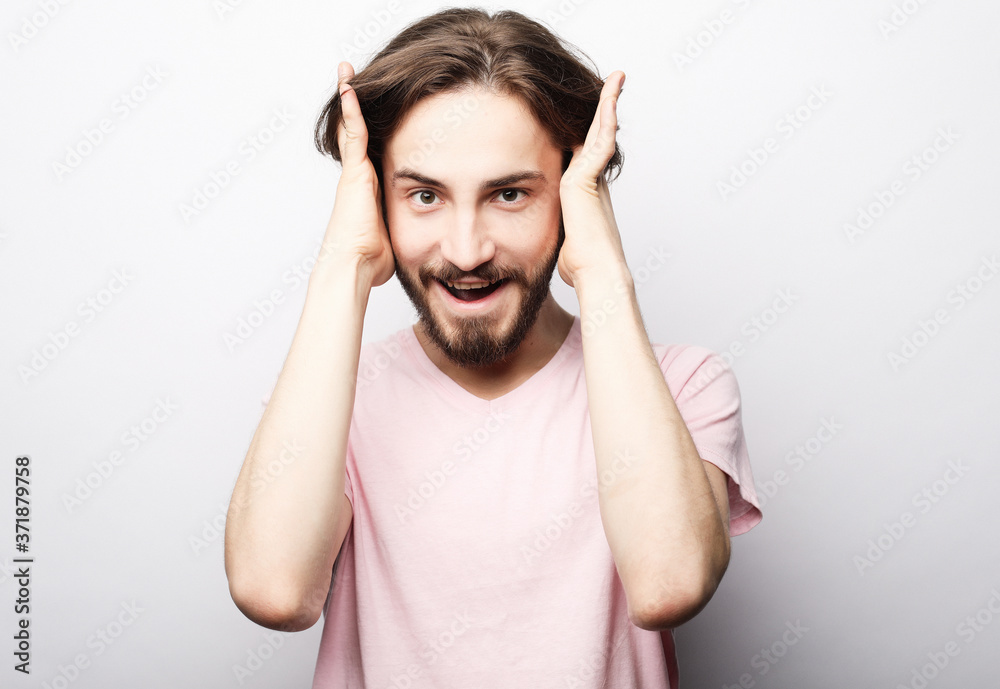 Naklejka premium lifestyle and people concept:young man has excited expression, dresssed casually