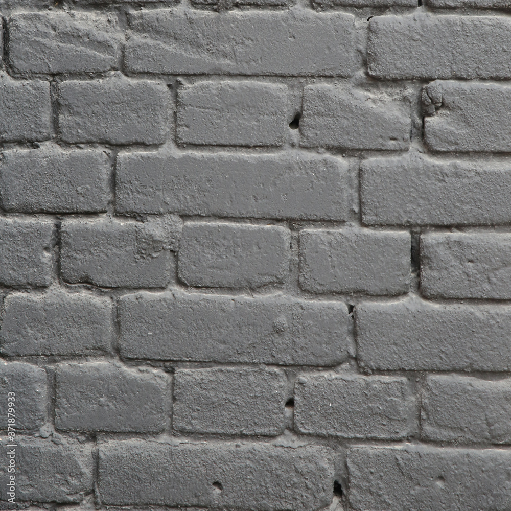 a piece of wall made of gray painted bricks a piece of wall made of gray painted bricks