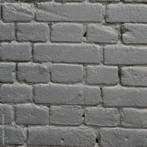 a piece of wall made of gray painted bricks