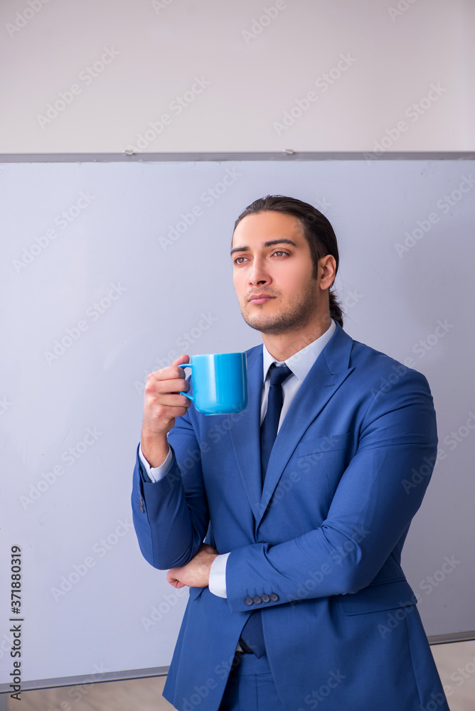 Young man employee in business presentation concept Young man employee in business presentation concept