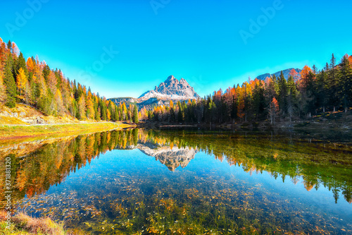 Stunning view of popular travel destination mountain lake Antorno in autumn