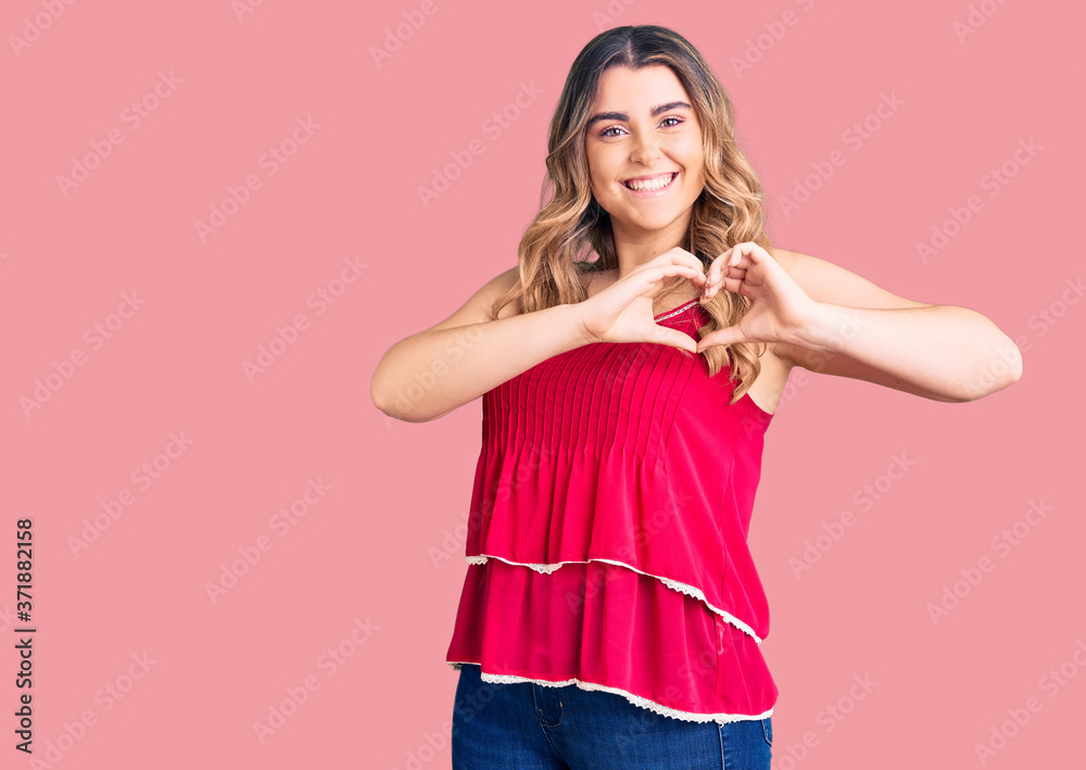 Young caucasian woman wearing casual clothes smiling in love showing heart symbol and shape with hands. romantic concept. Young caucasian woman wearing casual clothes smiling in love showing heart symbol and shape with hands. romantic concept.