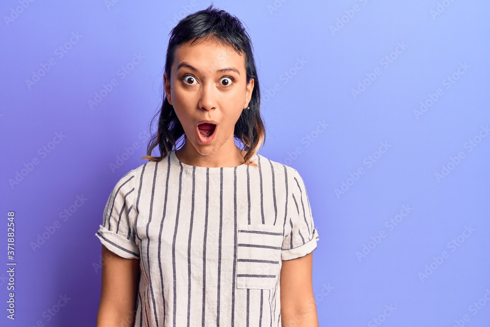 Young woman wearing casual clothes scared and amazed with open mouth for surprise, disbelief face Young woman wearing casual clothes scared and amazed with open mouth for surprise, disbelief face