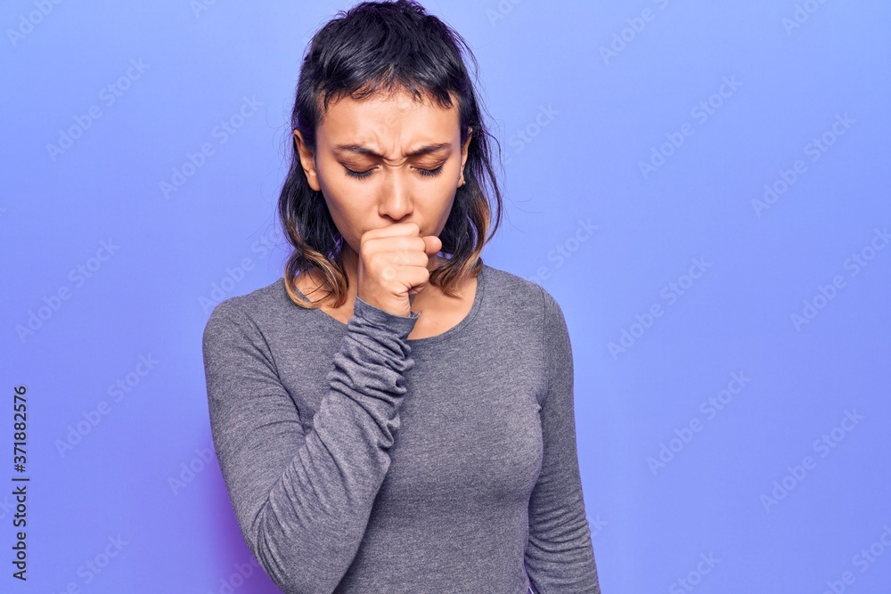 Young woman wearing casual clothes feeling unwell and coughing as symptom for cold or bronchitis. health care concept. Young woman wearing casual clothes feeling unwell and coughing as symptom for cold or bronchitis. health care concept.
