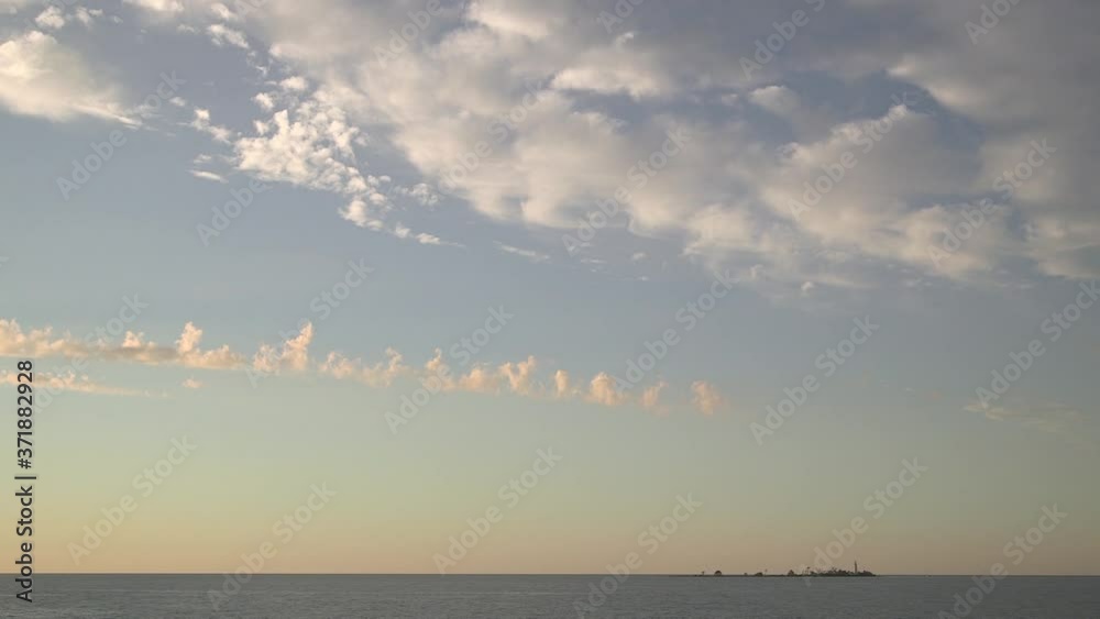 Sunset skyline with clouds moving wide static glowing gold yellow painting Lake Huron daytime Ontario Sunset skyline with clouds moving wide static glowing gold yellow painting Lake Huron daytime Ontario