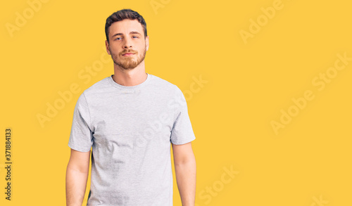 Wallpaper Mural Handsome young man with bear wearing casual tshirt relaxed with serious expression on face. simple and natural looking at the camera. Torontodigital.ca