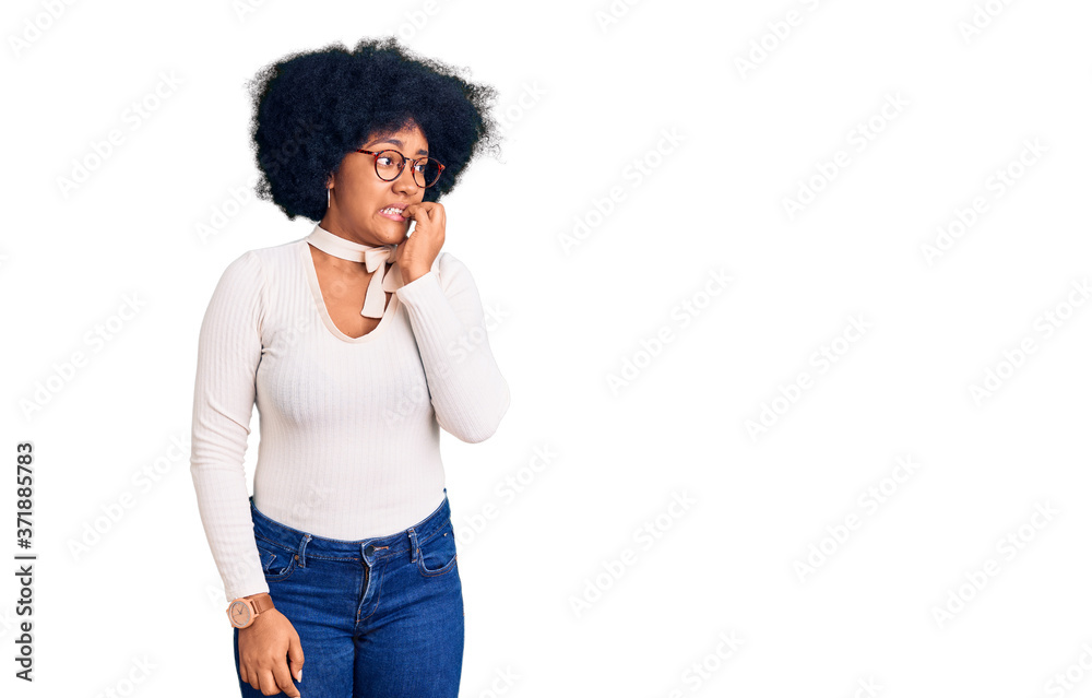 Young african american girl wearing casual clothes and glasses looking stressed and nervous with hands on mouth biting nails. anxiety problem. Young african american girl wearing casual clothes and glasses looking stressed and nervous with hands on mouth biting nails. anxiety problem.