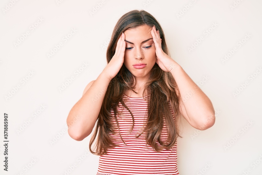 Beautiful young caucasian woman wearing casual clothes suffering from headache desperate and stressed because pain and migraine. hands on head. Beautiful young caucasian woman wearing casual clothes suffering from headache desperate and stressed because pain and migraine. hands on head.