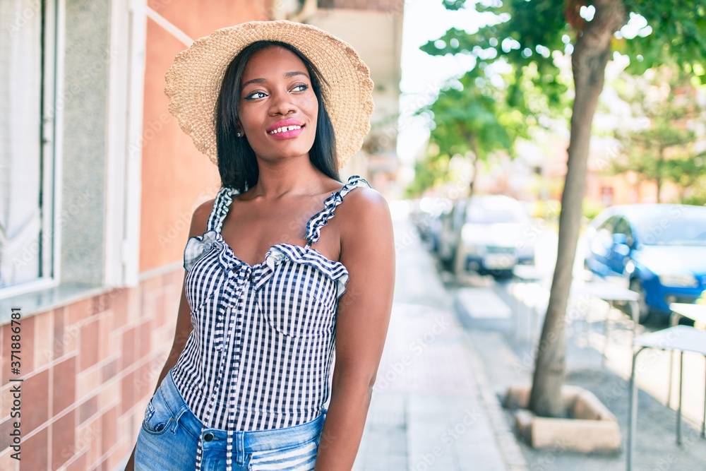 Young african american woman on vacation smiling happy walking at street of city