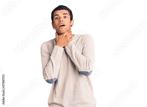 Young african amercian man wearing casual clothes shouting and suffocate because painful strangle. health problem. asphyxiate and suicide concept.