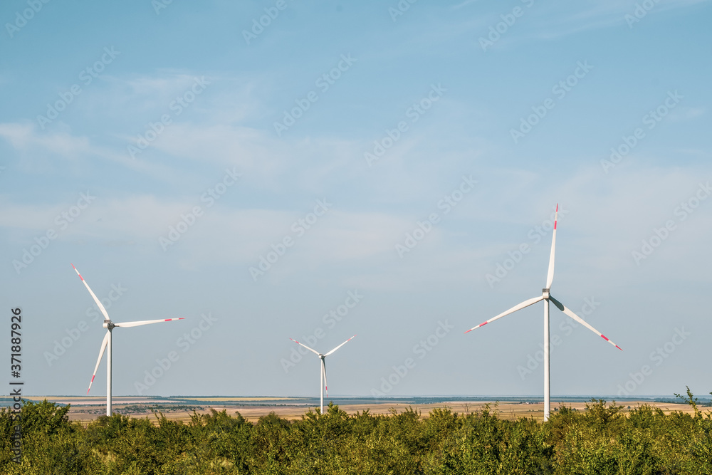 Wind turbines in an arid landscape. An alternative way of generating electricity from the wind. Innovative technologies for the future with zero emissions. Copy space. Wind turbines in an arid landscape. An alternative way of generating electricity from the wind. Innovative technologies for the future with zero emissions. Copy space.