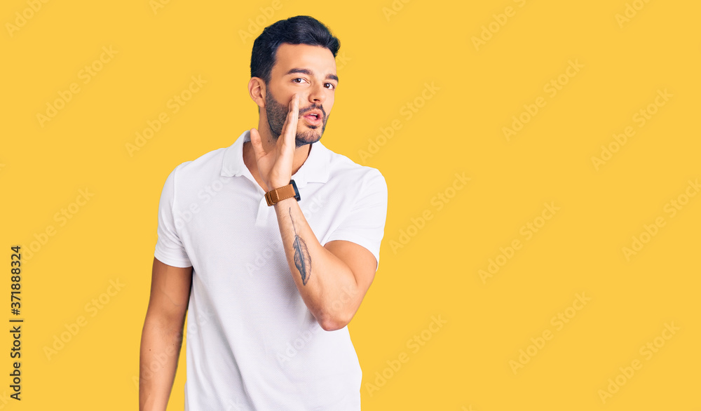 Young handsome hispanic man wearing casual clothes hand on mouth telling secret rumor, whispering malicious talk conversation Young handsome hispanic man wearing casual clothes hand on mouth telling secret rumor, whispering malicious talk conversation