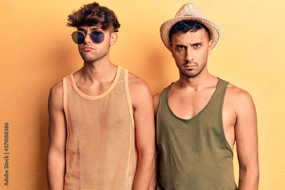 Young gay couple wearing summer clothes skeptic and nervous, frowning upset because of problem. negative person. Young gay couple wearing summer clothes skeptic and nervous, frowning upset because of problem. negative person.