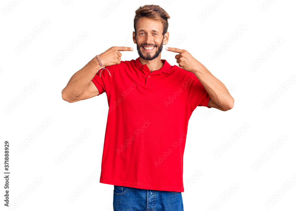 Handsome blond man with beard wearing casual clothes smiling cheerful showing and pointing with fingers teeth and mouth. dental health concept. Handsome blond man with beard wearing casual clothes smiling cheerful showing and pointing with fingers teeth and mouth. dental health concept.