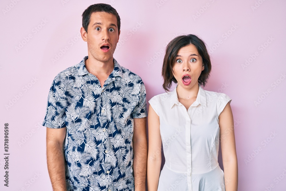Beautiful couple wearing casual clothes afraid and shocked with surprise and amazed expression, fear and excited face. Beautiful couple wearing casual clothes afraid and shocked with surprise and amazed expression, fear and excited face.