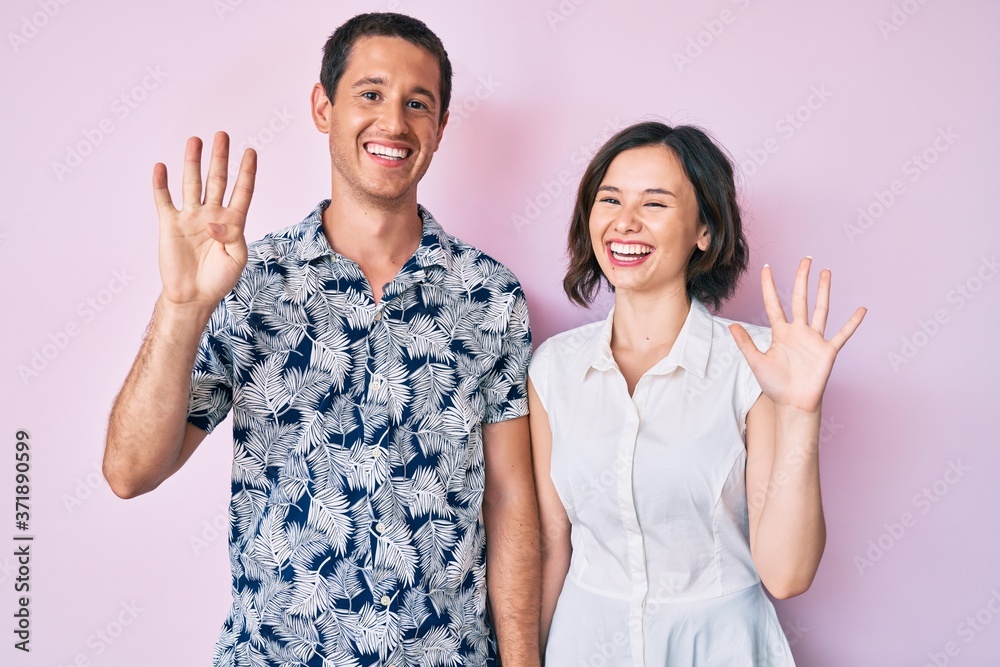 Beautiful couple wearing casual clothes showing and pointing up with fingers number nine while smiling confident and happy. Beautiful couple wearing casual clothes showing and pointing up with fingers number nine while smiling confident and happy.