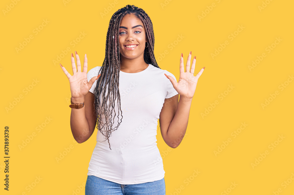 Young african american woman with braids wearing casual clothes showing and pointing up with fingers number ten while smiling confident and happy. Young african american woman with braids wearing casual clothes showing and pointing up with fingers number ten while smiling confident and happy.