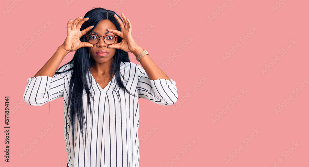 Young african american woman wearing casual clothes and glasses trying to open eyes with fingers, sleepy and tired for morning fatigue Young african american woman wearing casual clothes and glasses trying to open eyes with fingers, sleepy and tired for morning fatigue