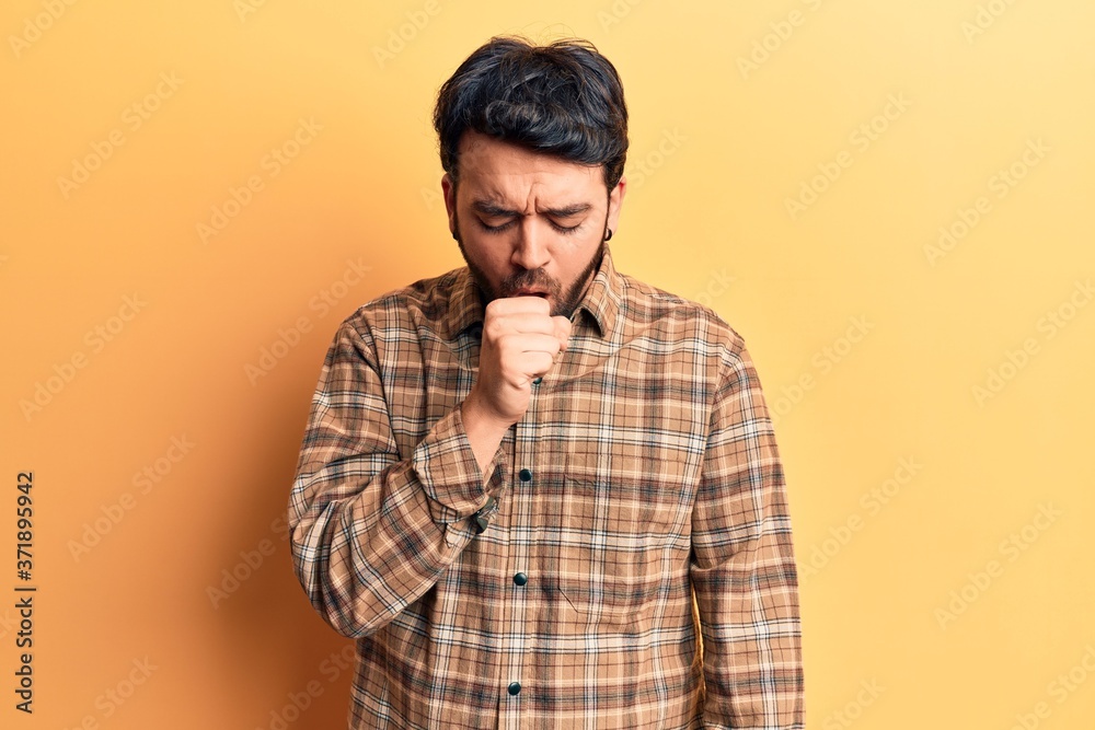 Young hispanic man wearing casual clothes feeling unwell and coughing as symptom for cold or bronchitis. health care concept.