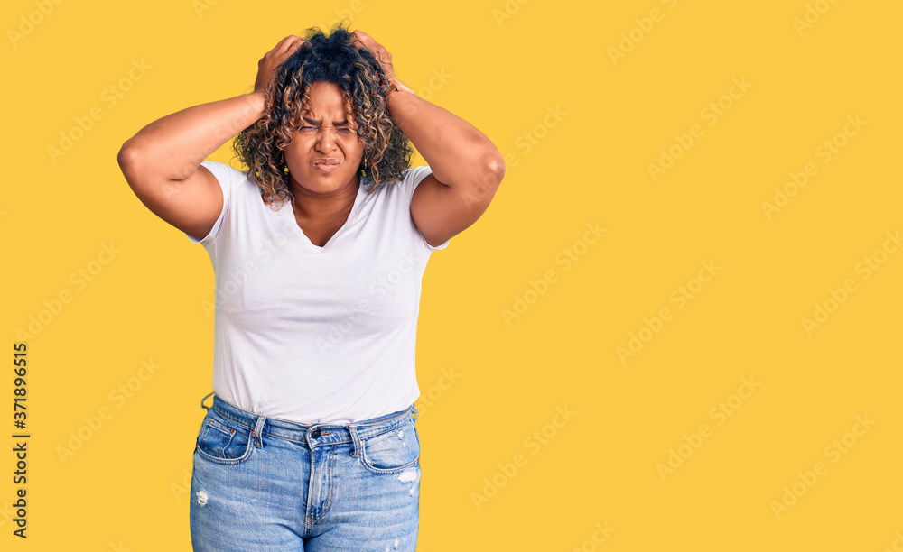 Young african american plus size woman wearing casual clothes suffering from headache desperate and stressed because pain and migraine. hands on head. Young african american plus size woman wearing casual clothes suffering from headache desperate and stressed because pain and migraine. hands on head.