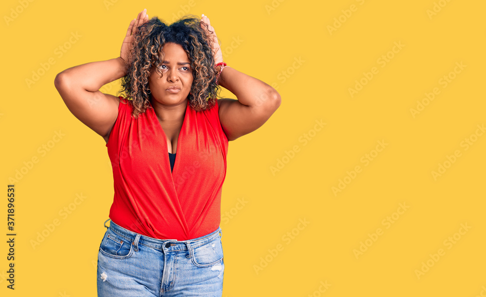 Young african american plus size woman wearing casual style with sleeveless shirt doing bunny ears gesture with hands palms looking cynical and skeptical. easter rabbit concept.