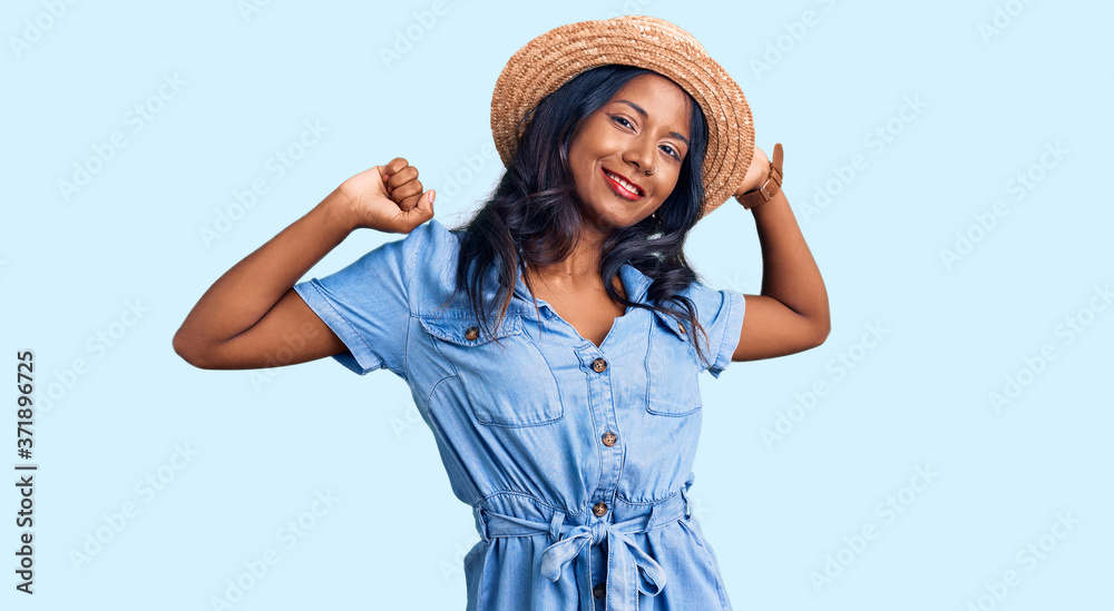 Young indian girl wearing summer hat stretching back, tired and relaxed, sleepy and yawning for early morning Young indian girl wearing summer hat stretching back, tired and relaxed, sleepy and yawning for early morning