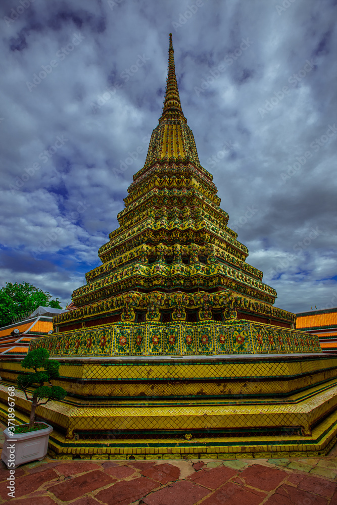 Fototapeta premium background of important religious attractions in Bangkok (Wat Phra Chetuphon (Wat Pho - reclining Buddha), a large pagoda and beautiful sculptural art give future generations to explore its history