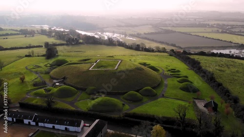 Meghalitic neolitic tomb Knowth aerial orbit shot. Complex located near by Newgrange, River Boyne valley, Ireland. photo