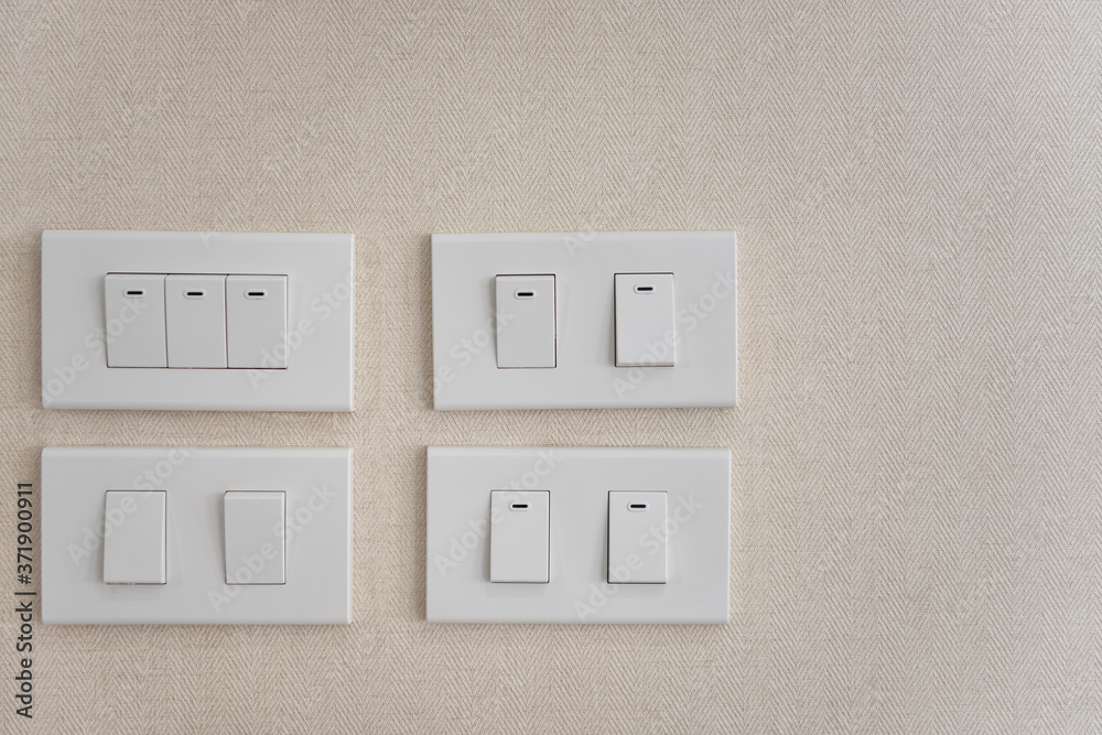 White lighting switchs on concrete wall. White lighting switchs on concrete wall.