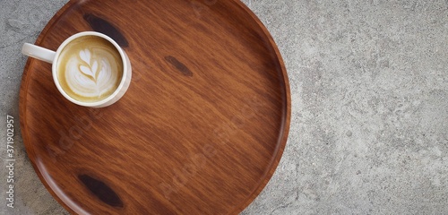 Wooden tray mockup with coffee cup on concrete.