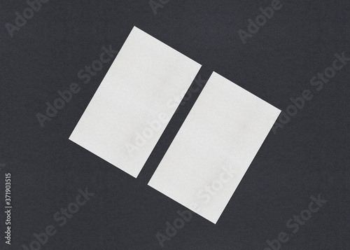 Blank white Business card mockup stacks on grey textured paper background. © shaadjutt36