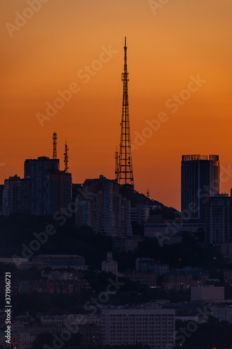 Dawn in Vladivostok. The TV tower stands on a hill against the backdrop of a bright dawn