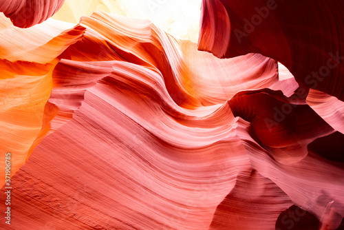 Light rays in the enigmatic Lower Antelope Canyon in Page Arizona with natural landscapes of bright sandstones stacked in flaky fire waves in a narrow sandy labyrinth