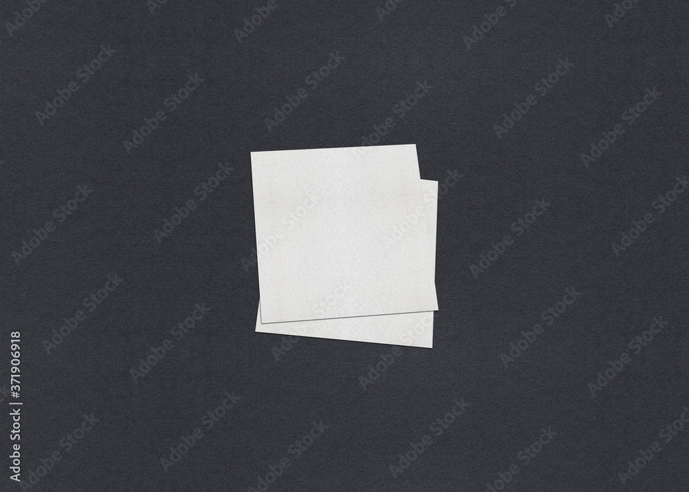 Blank white Business card mockup stacks on grey textured paper background.