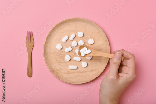 Assorted pharmaceutical medicine, Taking too much medication pills on spoon, Overdiagnosis drugs cause bad health. photo