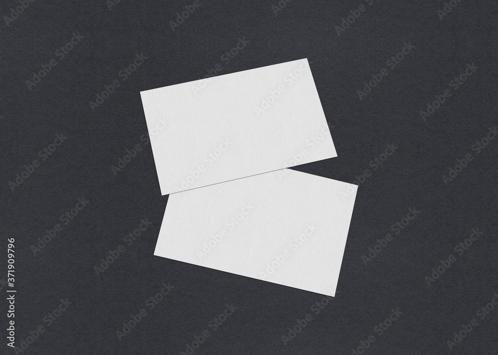 Blank white Business card mockup stacks on grey textured paper background.
