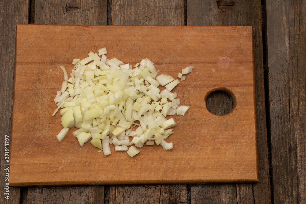 Chopped onion ready to cook. Onion on wooden background