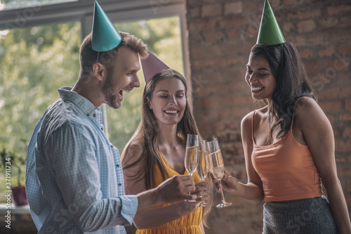 Young adults drinking alcohol at the birthday party