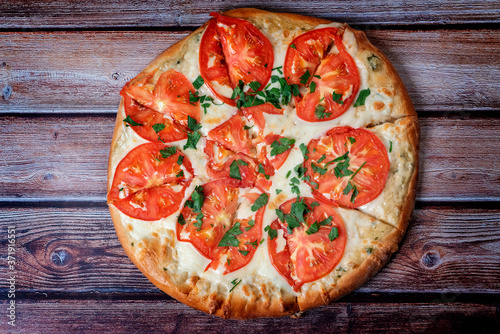 classic Italian pizza on a wooden table top view