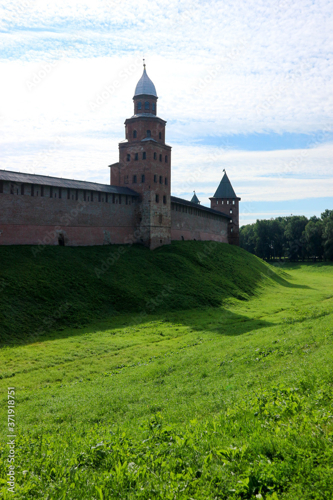View to Kokui tower and wall of the Velikiy (Great) Novgorod citadel (kremlin, detinets) in Russia under blue summer sky in the morning 
