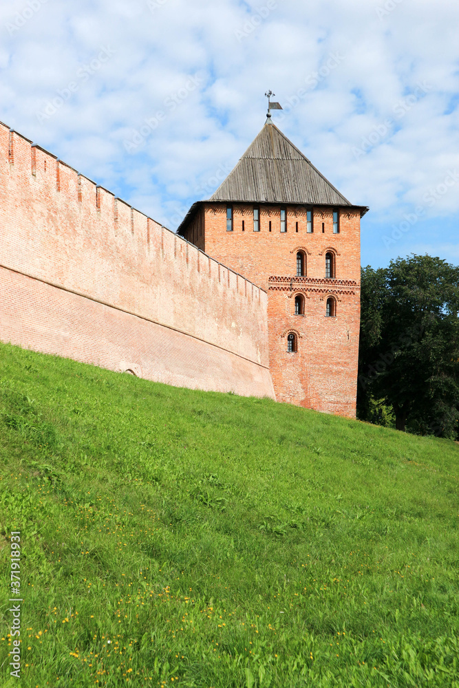 View to Vladimir tower and wall of the Velikiy (Great) Novgorod citadel (kremlin, detinets) in Russia under blue summer sky in the morning 