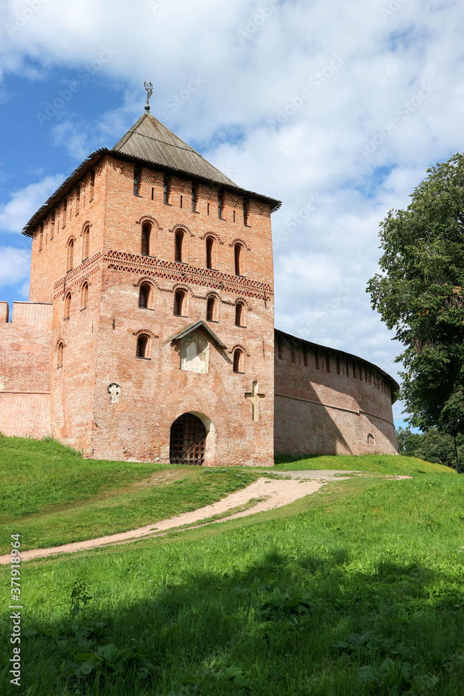 View to Vladimir tower and wall of the Velikiy (Great) Novgorod citadel (kremlin, detinets) in Russia under blue summer sky in the morning 