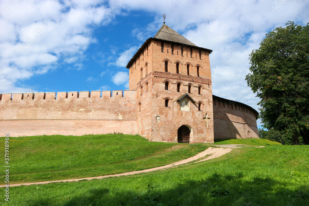 View to Vladimir tower and wall of the Velikiy (Great) Novgorod citadel (kremlin, detinets) in Russia under blue summer sky in the morning 